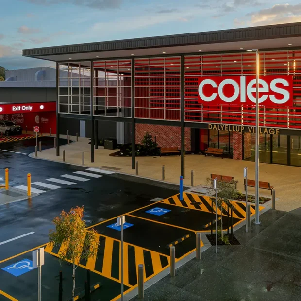 Exterior view of Coles Dallyellup Village shopping centre with accessible parking bays, pedestrian crossing and store entrance.
